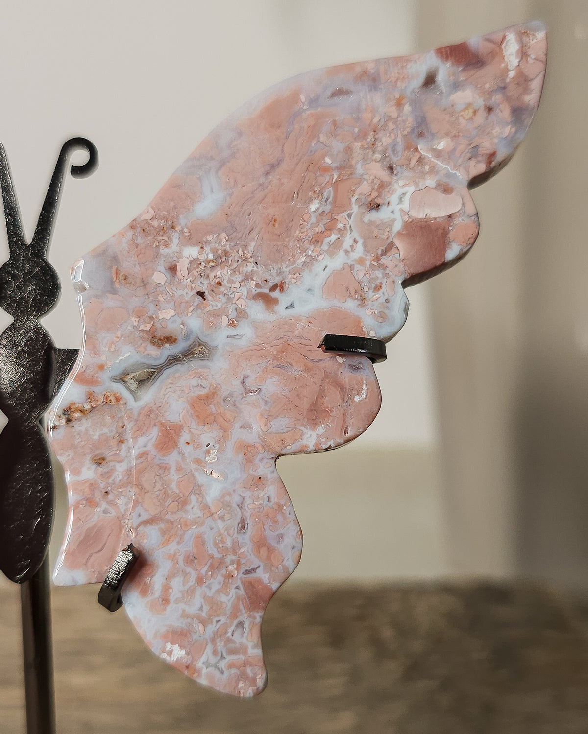 Pink Chalcedony with Agate butterfly wings on a  metal stand, featuring soft pink, cream and white natural banding.
