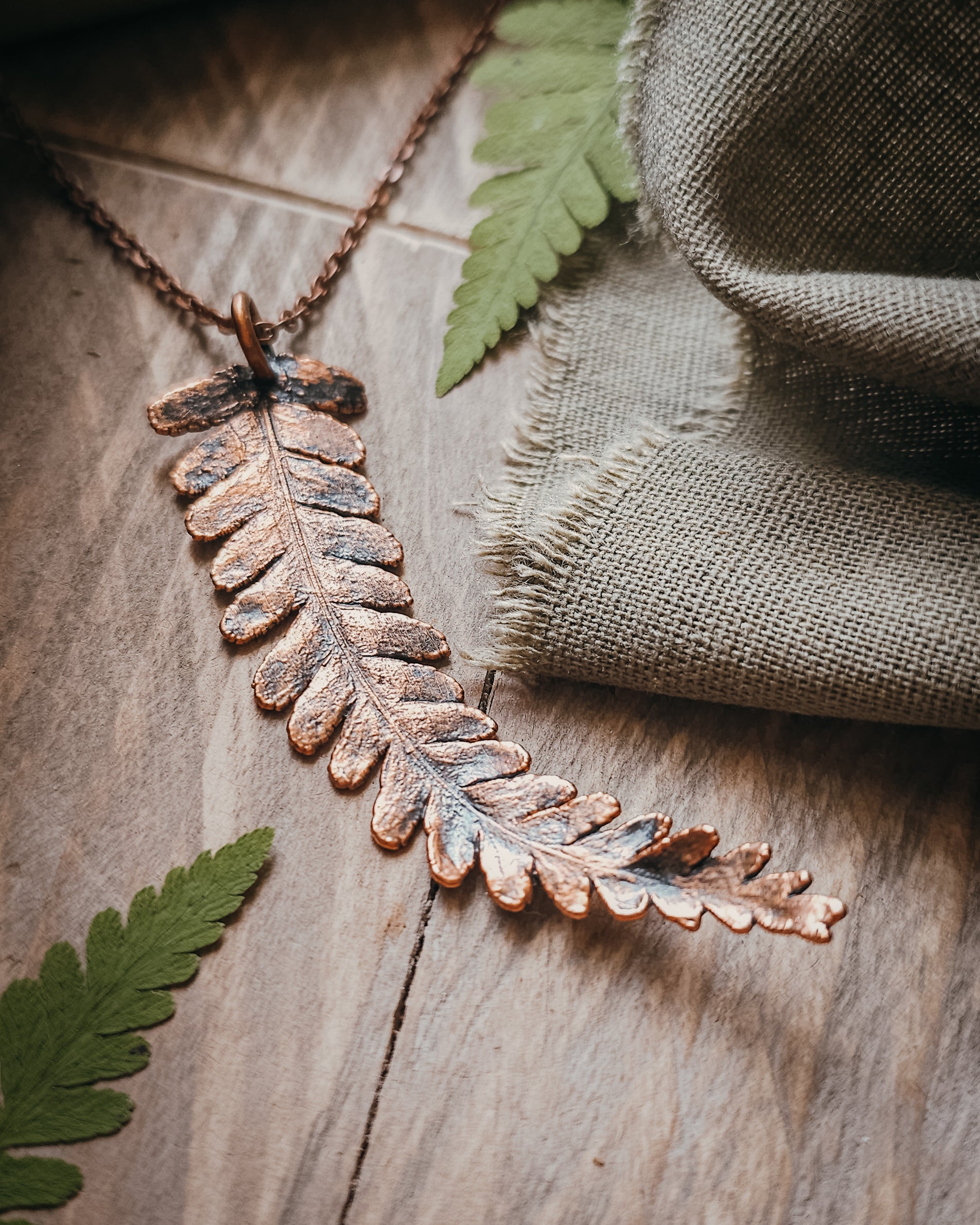 One-of-a-kind copper electroformed fern amulet, handcrafted in Scotland. A unique botanical statement necklace for nature lovers.
