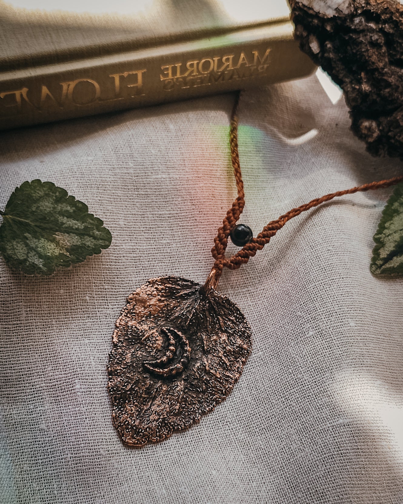 Handcrafted copper electroformed dead nettle leaf necklace with Golden Sheen Obsidian and handwoven micromacramé detailing.