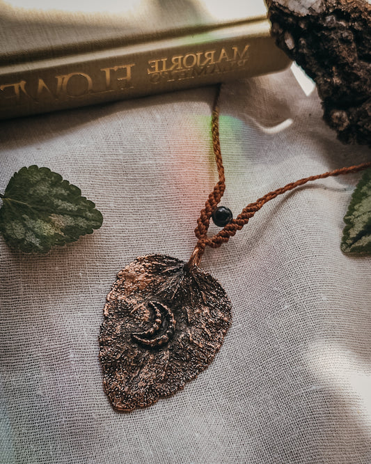 Handcrafted copper electroformed dead nettle leaf necklace with Golden Sheen Obsidian and handwoven micromacramé detailing.