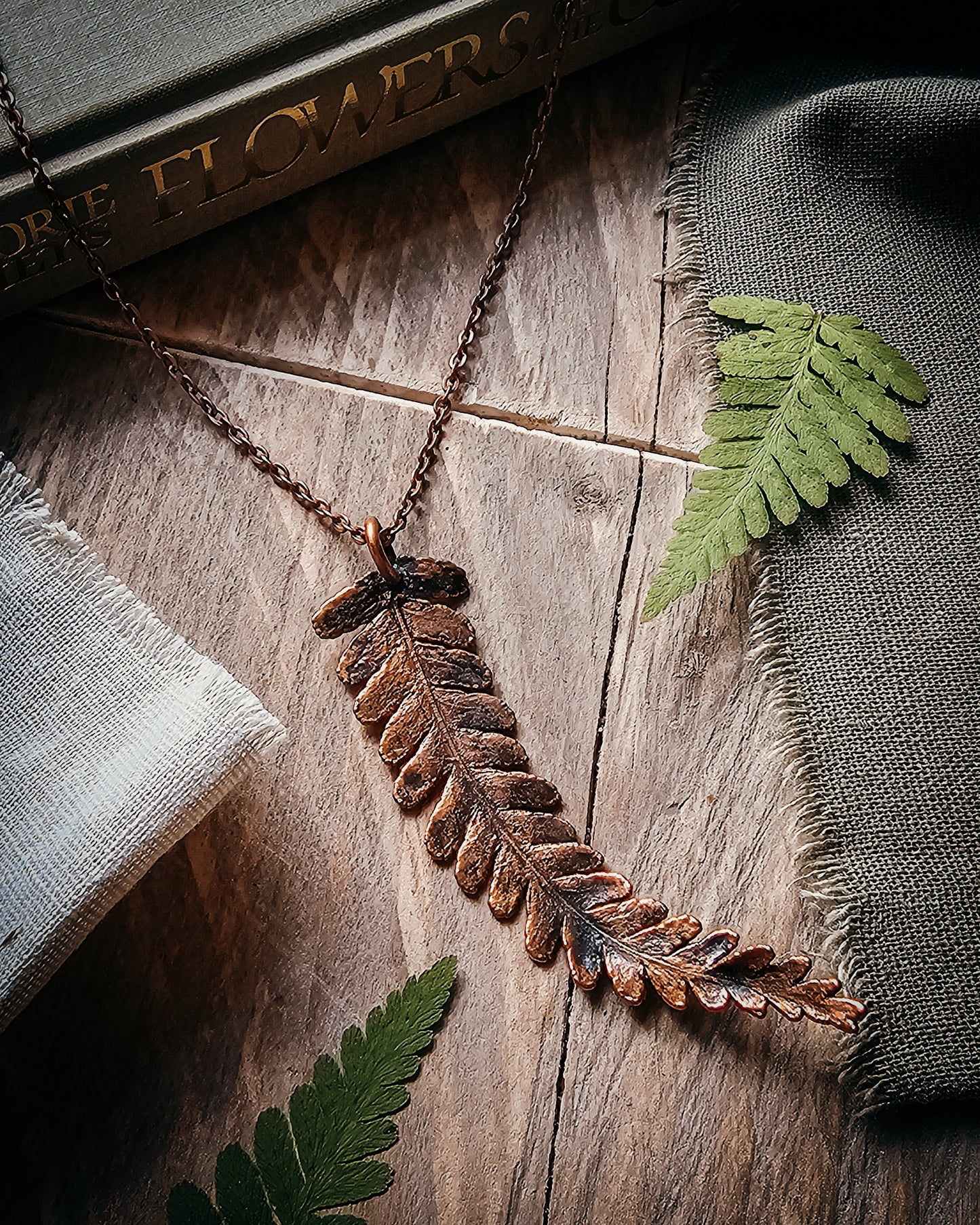 One-of-a-kind copper electroformed fern amulet, handcrafted in Scotland. A unique botanical statement necklace for nature lovers.
