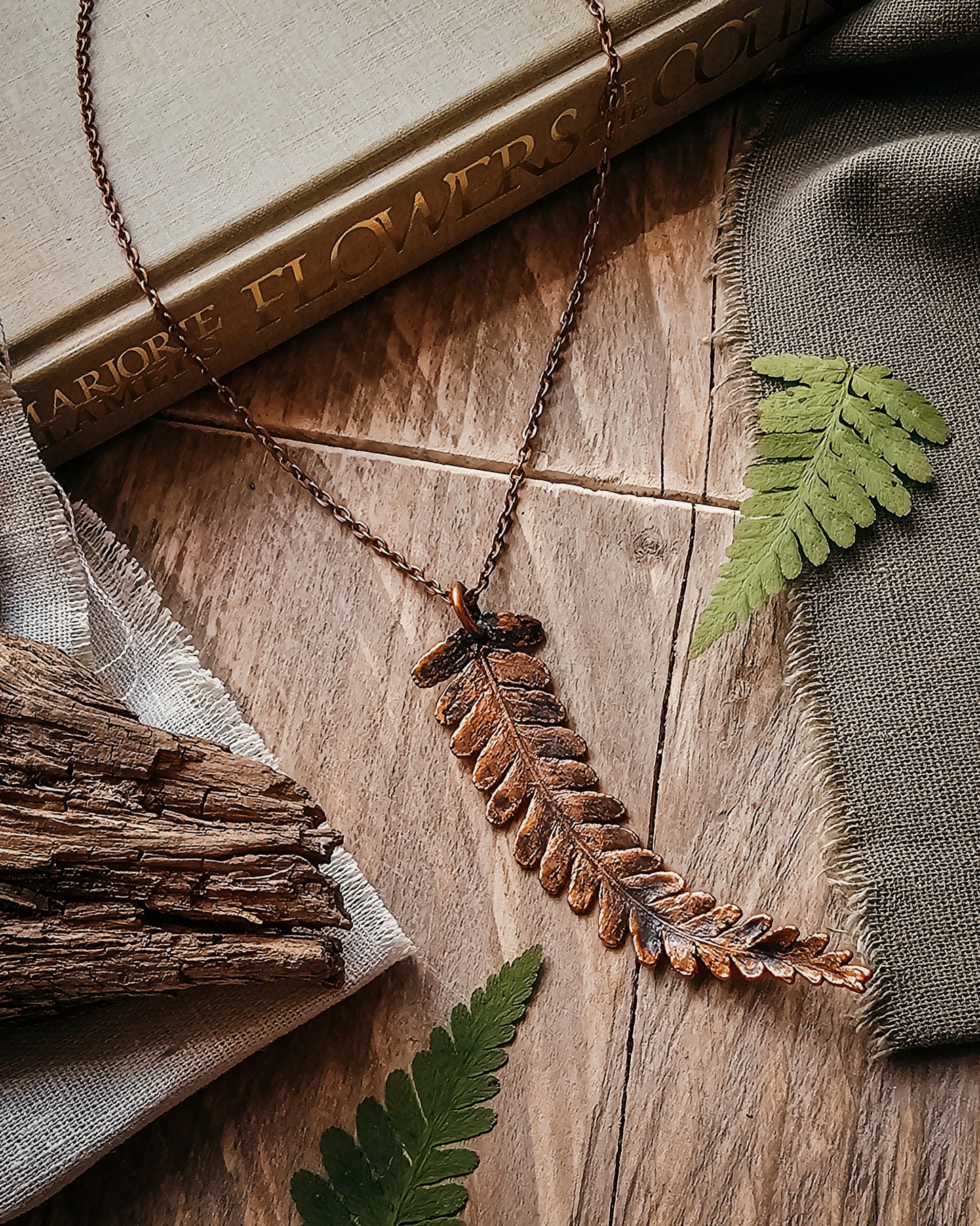 One-of-a-kind copper electroformed fern amulet, handcrafted in Scotland. A unique botanical statement necklace for nature lovers.
