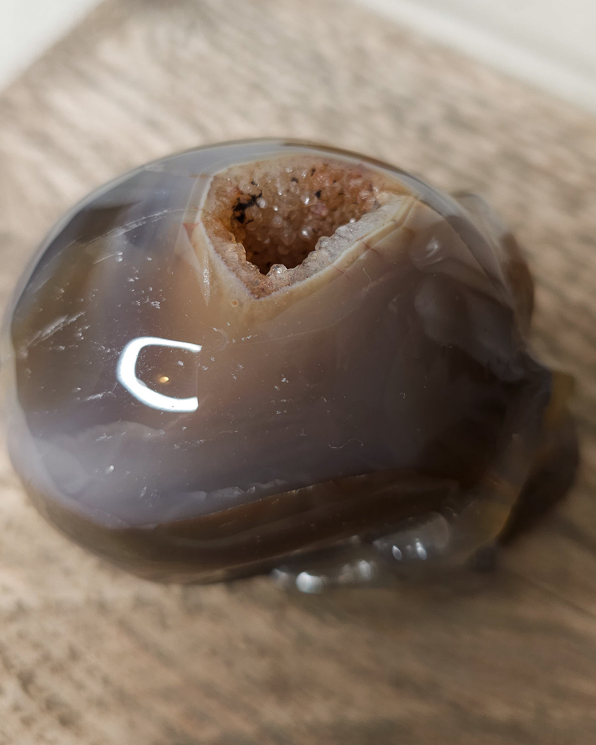 Smoky Agate skull carving with natural brown, charcoal grey and amber tones , translucent banding and a sparkling druzy  crystal cavity on the back.