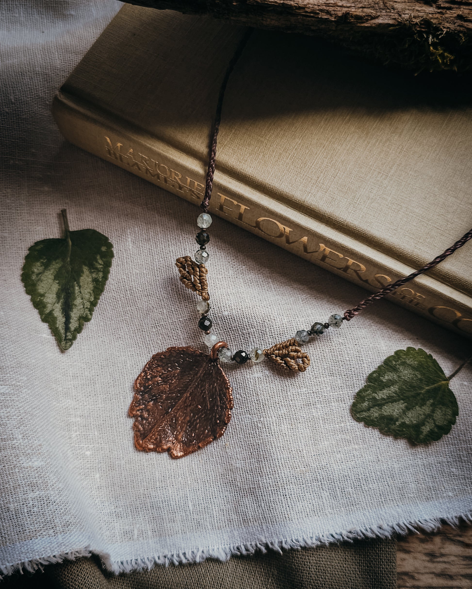 Handcrafted copper electroformed dead nettle leaf necklace with Prehnite and Epidote beads and intricate handwoven micromacramé detailing.