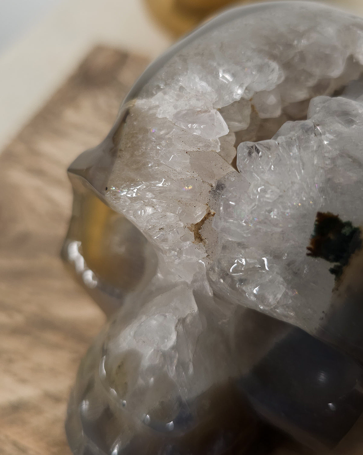 Large Druzy Agate skull carving with smoky grey and brown tones, natural white and pale blue banding, a sparkling quartz druzy cavity and tiny rainbow reflections in the crystals.