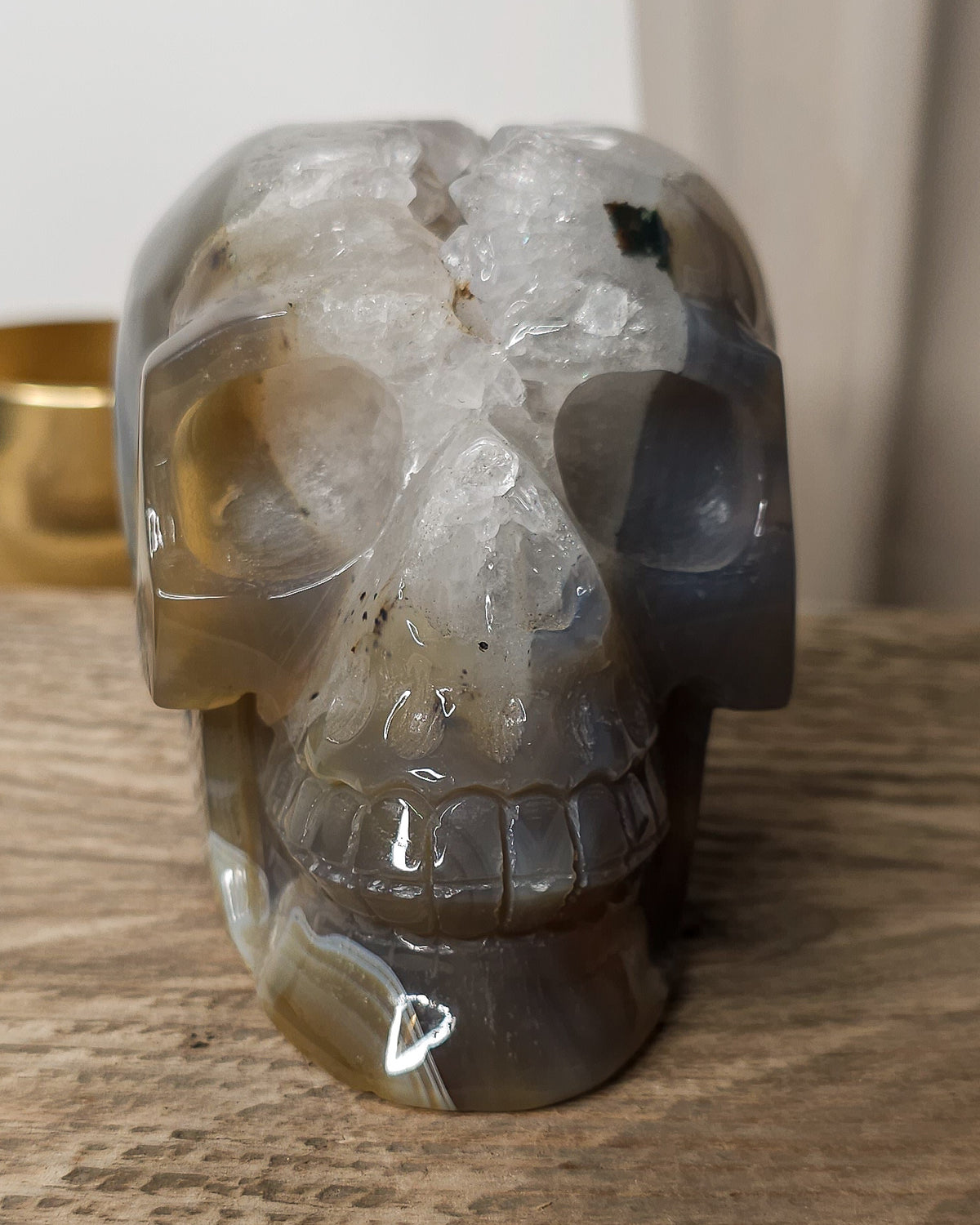 Large Druzy Agate skull carving with smoky grey and brown tones, natural white and pale blue banding, a sparkling quartz druzy cavity and tiny rainbow reflections in the crystals.