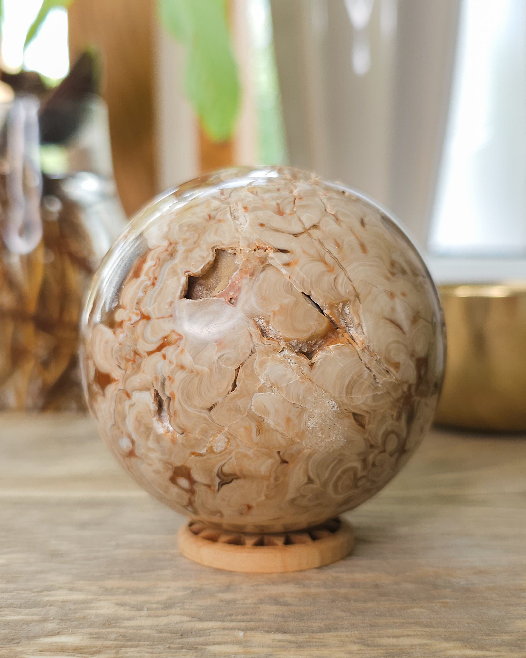 Chocolate Calcite sphere displaying crystal-filled opening and natural brown, cream and honey coloured bands.