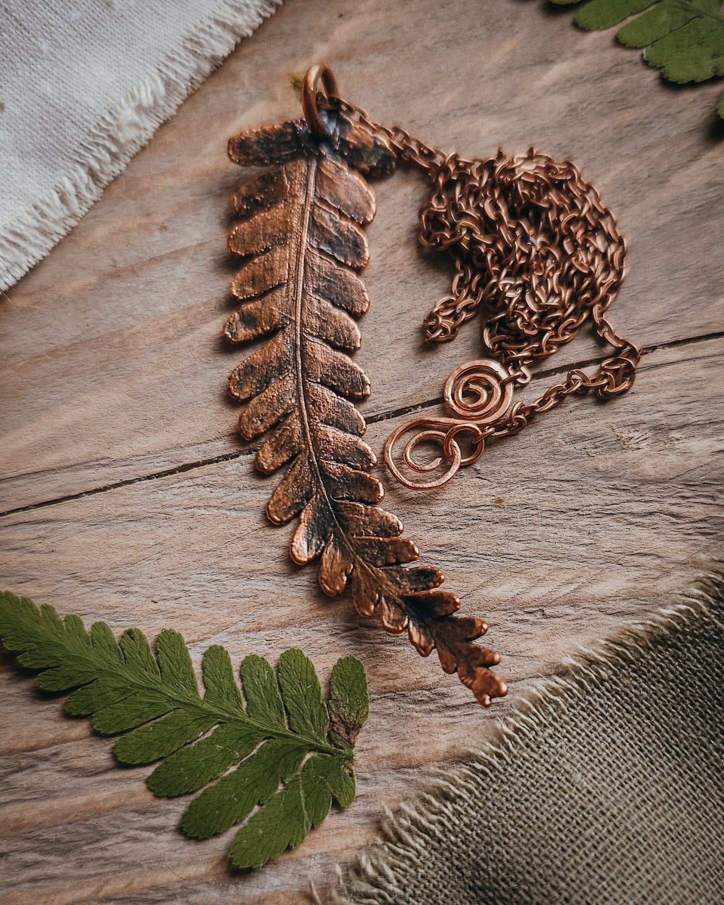 One-of-a-kind copper electroformed fern amulet, handcrafted in Scotland. A unique botanical statement necklace for nature lovers.
