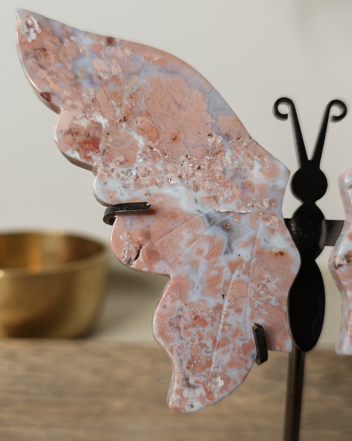 Pink Chalcedony with Agate butterfly wings on a  metal stand, featuring soft pink, cream and white natural banding.