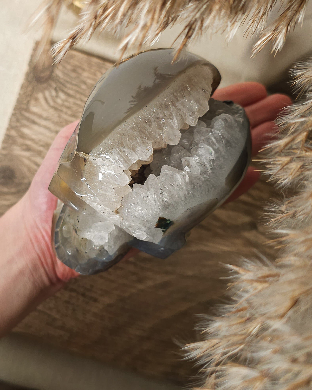 Large Druzy Agate skull carving with smoky grey and brown tones, natural white and pale blue banding, a sparkling quartz druzy cavity and tiny rainbow reflections in the crystals.