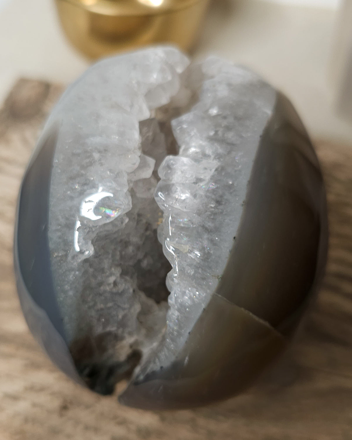 Large Druzy Agate skull carving with smoky grey and brown tones, natural white and pale blue banding, a sparkling quartz druzy cavity and tiny rainbow reflections in the crystals. 