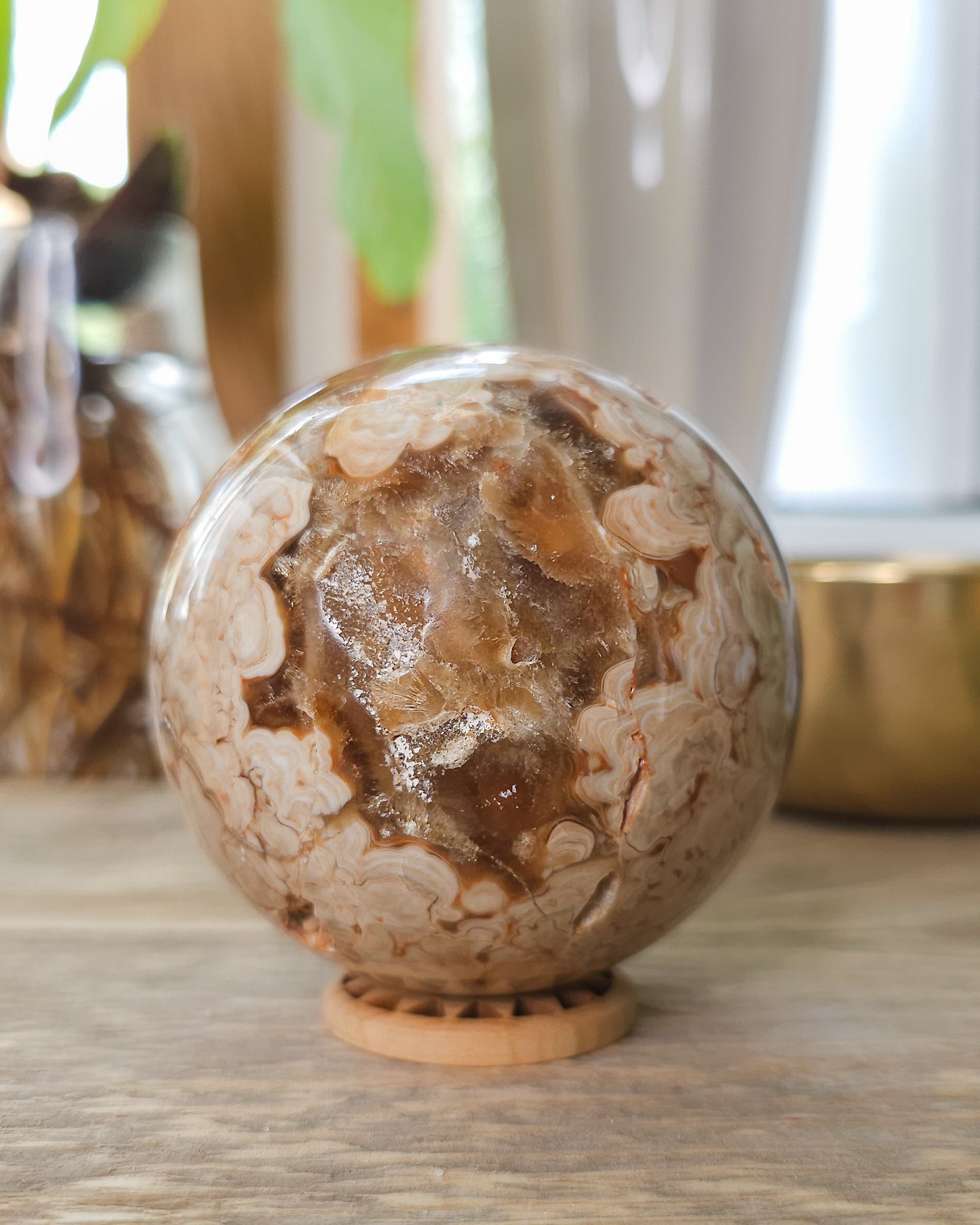 Chocolate Calcite sphere showing natural druzy crystal pocket and layered caramel banding.