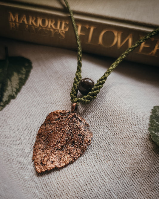 Scottish Botanical Amulet Nettle Spirit featuring a real copper electroformed dead nettle leaf with Brown Jasper bead and handwoven micromacramé detailing.
